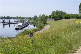 Dijk met bootsteigers